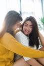 Beautiful young asian women LGBT lesbian happy couple sitting on bed hugging and smiling together in bedroom at home. Royalty Free Stock Photo