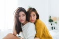 Beautiful young asian women LGBT lesbian happy couple sitting on bed hugging and smiling together in bedroom at home. Royalty Free Stock Photo