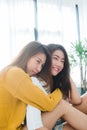 Beautiful young asian women LGBT lesbian couple sitting on bed hugging and smiling together in bedroom at home. Royalty Free Stock Photo