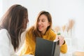 Beautiful young asian women LGBT lesbian happy couple sitting on bed reading book together near window in bedroom at home. Royalty Free Stock Photo