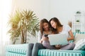Beautiful young asian women LGBT lesbian happy couple sitting on sofa buying online using laptop a computer and phone in living. Royalty Free Stock Photo
