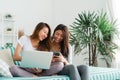 Beautiful young asian women LGBT lesbian happy couple sitting on sofa buying online using laptop a computer and phone. Royalty Free Stock Photo