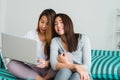 Beautiful young asian women LGBT lesbian happy couple sitting on sofa buying online using laptop in living room at home. Royalty Free Stock Photo