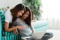 Beautiful young asian women LGBT lesbian happy couple sitting on sofa buying online using laptop in living room at home. Royalty Free Stock Photo