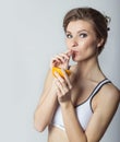 Beautiful young athletic girl energetic happy drinking orange juice, healthy lifestyle Royalty Free Stock Photo