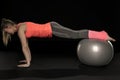 Beautiful young athletic woman exercising with a gymnastics ball Royalty Free Stock Photo