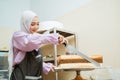 beautiful young baker making cake at her kitchen