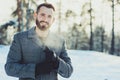 Beautiful young bearded men relaxing on winter walk in snowy forest, candid capture Royalty Free Stock Photo