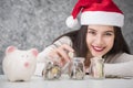 Beautiful young beautiful girl saving money for Christmas and holiday season Royalty Free Stock Photo