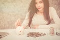 Beautiful young beautiful girl saving money for Christmas and holiday season Royalty Free Stock Photo