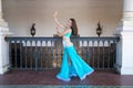 Beautiful young belly dancer is posing for the camera in a photo shoot. The woman is beautiful and dressed in traditional clothes Royalty Free Stock Photo