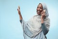 The beautiful young black muslim girl wearing gray hijab, with a happy smile on her face.