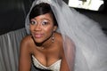 Young black bride looks at the camera and smiles in wedding car Royalty Free Stock Photo