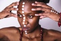 Beautiful black girl with faceart touchs her face Royalty Free Stock Photo