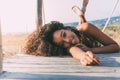 Beautiful young black woman lying down in a wooden foot bridge Royalty Free Stock Photo