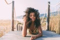 Beautiful young black woman lying down in a wooden foot bridge Royalty Free Stock Photo