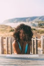 Beautiful young black woman lying down in a wooden foot bridge Royalty Free Stock Photo