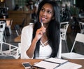 Beautiful young black woman sitting at cafe and writing notes, lifestyle concept Royalty Free Stock Photo