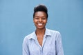 Beautiful young black woman smiling against blue background Royalty Free Stock Photo