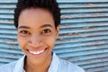 Beautiful young black woman smiling against blue background Royalty Free Stock Photo