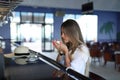 Beautiful young blond drinking coffee. attractive girl sitting in cafe. Relaxing. Summer vacation. Summertime. Royalty Free Stock Photo