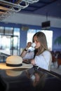 Beautiful young blond drinking coffee. attractive girl sitting in cafe. Relaxing. Summer vacation. Summertime. Royalty Free Stock Photo