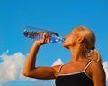 Beautiful young blond girl drinking water Royalty Free Stock Photo