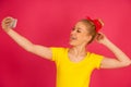 Beautiful young blond teenage woman in yellow t shirt taking se Royalty Free Stock Photo