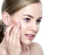 Beautiful Young Blond Woman applying Face cream under her eyes. Facial treatment. Cosmetology, beauty and spa concept Royalty Free Stock Photo