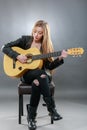 Beautiful young,blond woman with a electric guitar Royalty Free Stock Photo