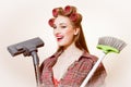 Beautiful young blond woman holding vacuum cleaner and brush looking in camera on white copy space background Royalty Free Stock Photo