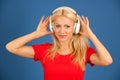 Beautiful young blond woman listening music over vibrant color b Royalty Free Stock Photo