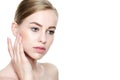 Beautiful Young Blond Woman with Perfect Skin touching her face. Facial treatment. Cosmetology, beauty and spa concept