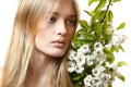 Beautiful young blond woman with spring flowers Royalty Free Stock Photo