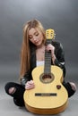 A beautiful young blonde with a classical guitar Royalty Free Stock Photo