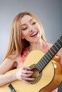 A beautiful young blonde with a classical guitar Royalty Free Stock Photo