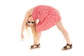 Beautiful young blonde girl bent over doing stretches and wearing pink and white polka dot dress and classy white framed Royalty Free Stock Photo