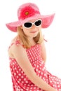 Beautiful young blonde girl in big pink floppy hat, polka dot dress and classy white framed sunglasses. Isolated on white studio