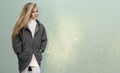 Beautiful young blonde girl in a coat and boots posing for fashion,