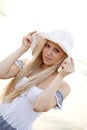 Beautiful young blonde girl in hat on the beach Royalty Free Stock Photo