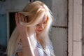 Beautiful young blonde girl with a pretty face and beautiful eyes smiling. Portrait of a woman with long hair and amazing looks. Royalty Free Stock Photo