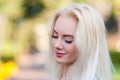 Beautiful young blonde girl with a pretty face and beautiful smiling eyes. Portrait of a woman with long hair and amazing looks. Royalty Free Stock Photo