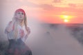 Beautiful young blonde girl with a red scarf, a traditional romanian blouse and a red and black skirt Royalty Free Stock Photo