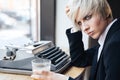 Beautiful young blonde girl sitting and drinking in cafe Royalty Free Stock Photo