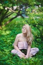 Beautiful young blonde girl in sunglasses with puffy lips and feminine body posing on the street style on sunny day