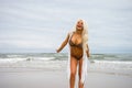 Beautiful young blonde haired woman on the beach in bikini smiling Royalty Free Stock Photo