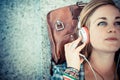 Beautiful young blonde hipster woman listening music Royalty Free Stock Photo
