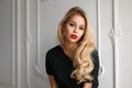 Beautiful young blonde model girl with red lips