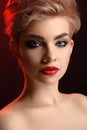 Beautiful young blonde red lipped woman posing in artistic red l Royalty Free Stock Photo