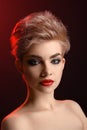 Beautiful young blonde red lipped woman posing in artistic red l Royalty Free Stock Photo